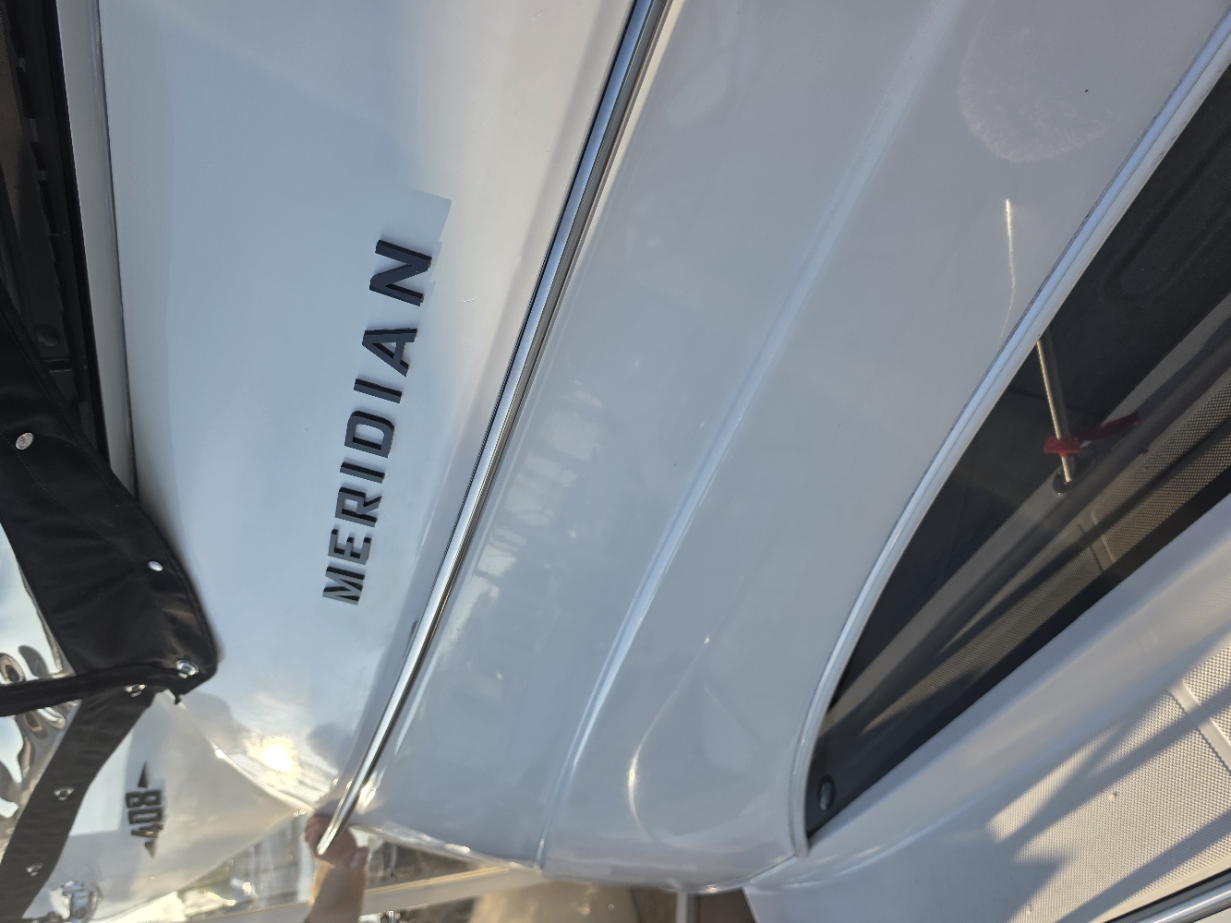 Detailed white hull side of Holy Ship with the Meridian badge and polished stainless rub rail